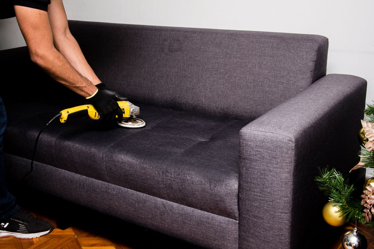 gallery-05 A professional performs sofa cleaning with a grinder in an indoor setting, showcasing efficient service.